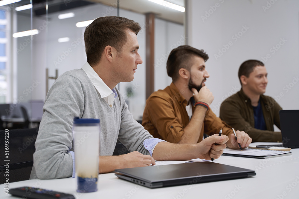Making great decisions. Team members discuss software features during the meeting in IT office