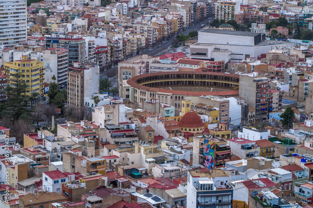 contemporary buildings in the city center against the overcast mountains