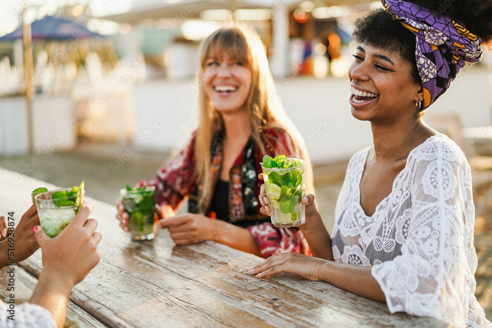 Multiracial happy friends having fun drinking mojitos at beach party - Focus on african girl face