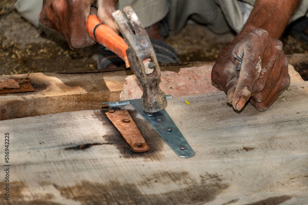 Poor carpenter working on wood door repair Poor carpenter working on wood door repair