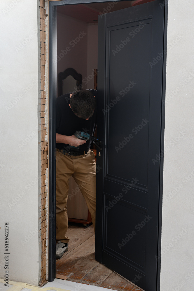 installation of a door handle using a manual screwdriver, assembly work. installation of a door handle using a manual screwdriver, assembly work.