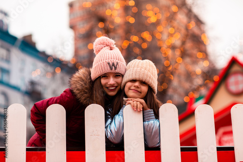 Wallpaper Mural Two sisters, girlfriends, walk around the New Year's location in the city. They are cheerful and happy. Christmas, new year. vacation Torontodigital.ca