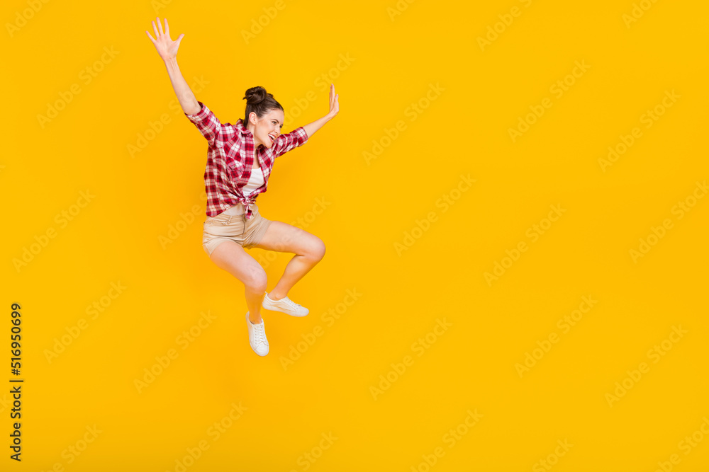 Full length photo of overjoyed cheerful girl enjoy free time jumping travel isolated on yellow color background Full length photo of overjoyed cheerful girl enjoy free time jumping travel isolated on yellow color background