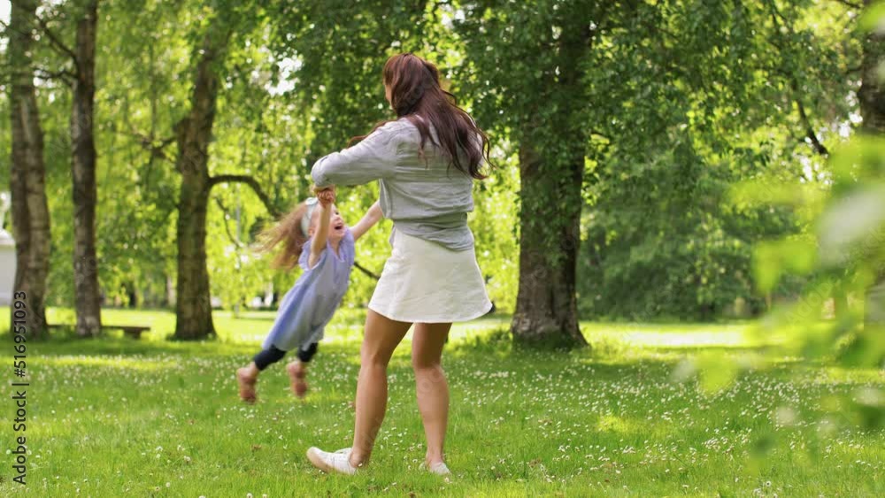 family, motherhood and people concept - happy mother with little daughter playing at summer park or garden family, motherhood and people concept - happy mother with little daughter playing at summer park or garden