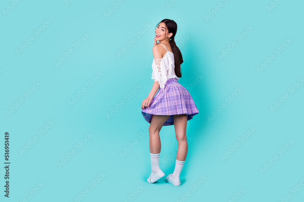 Full length photo of funny pretty lady wear white top walking empty space isolated turquoise color background Full length photo of funny pretty lady wear white top walking empty space isolated turquoise color background