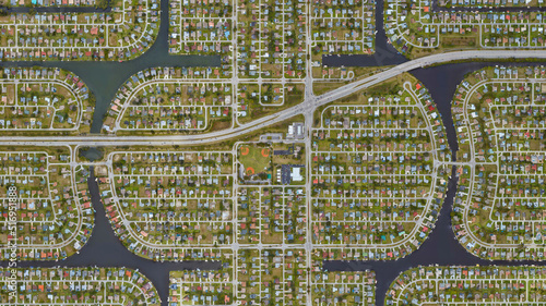 Cape Coral, Florida, settlement of the wealthy district with water channels and lake, looking down aerial view from above – Bird’s eye view Cape Coral, Lee County, Florida, USA