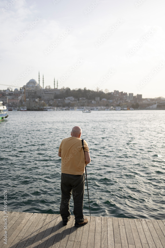 Back view of fisherman. İstanbul city view. 