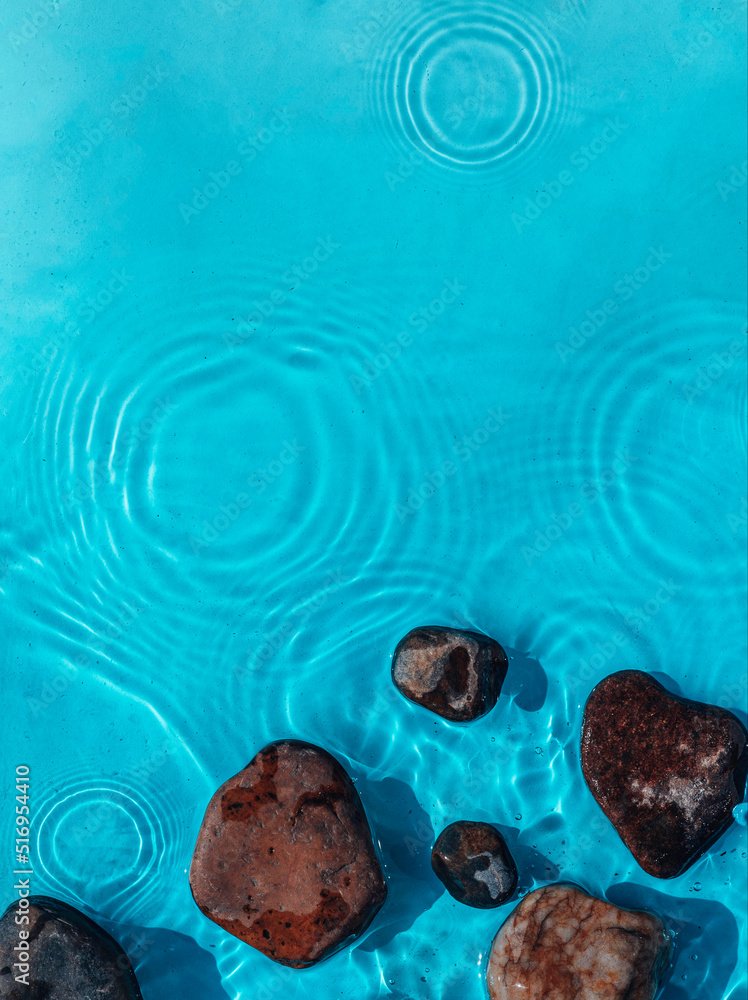 Sea stones in the sea water. Pebbles under water. Stones In Blue Water