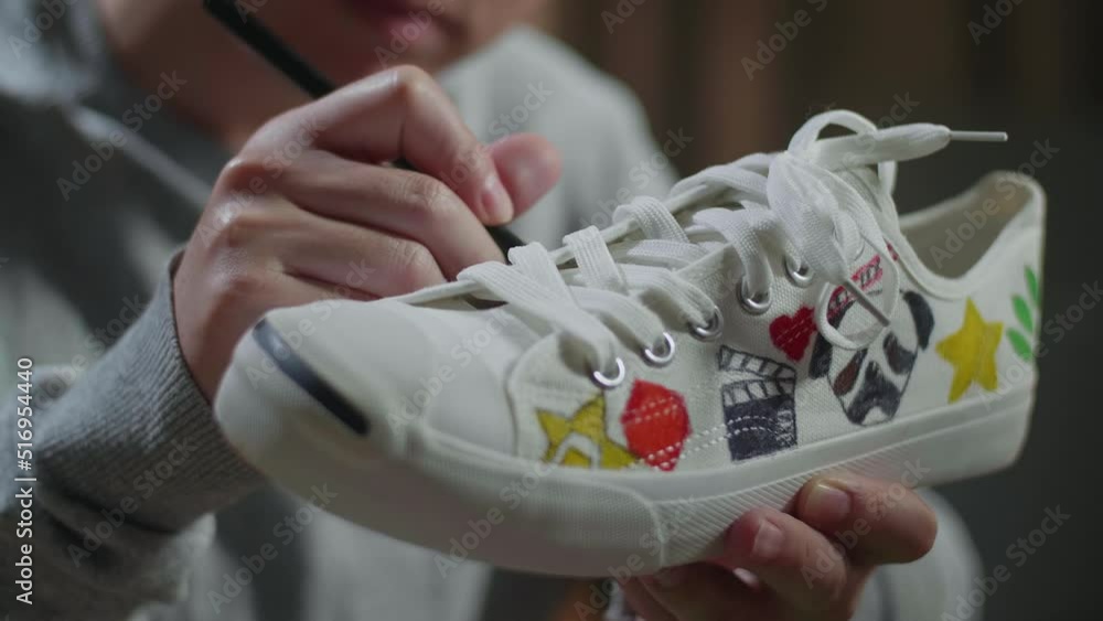 Close Up Of Male Footwear Designer'S Hands Putting Coloured Unique Patterns On Sneakers At Home
Close Up Of Male Footwear Designer'S Hands Putting Coloured Unique Patterns On Sneakers At Home