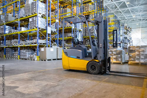 Interior of a modern warehouse with forklifts. Pallet stacker truck equipment at warehouse. Forklift loader