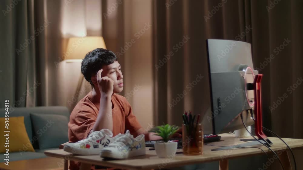Asian Boy Footwear Designer Thinking While Working On A Desktop Computer At Home
Asian Boy Footwear Designer Thinking While Working On A Desktop Computer At Home
