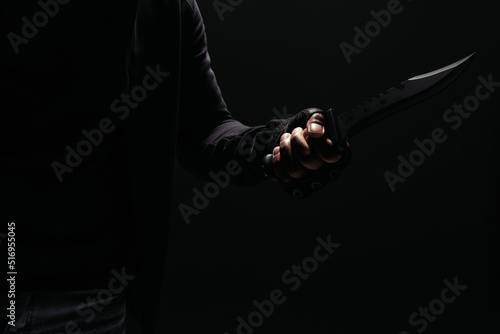 Cropped view of african american robber holding knife isolated on black