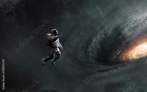 3D render of Astronaut looks at black hole and event horizon. 5K realistic science fiction art. Elements of image provided by Nasa