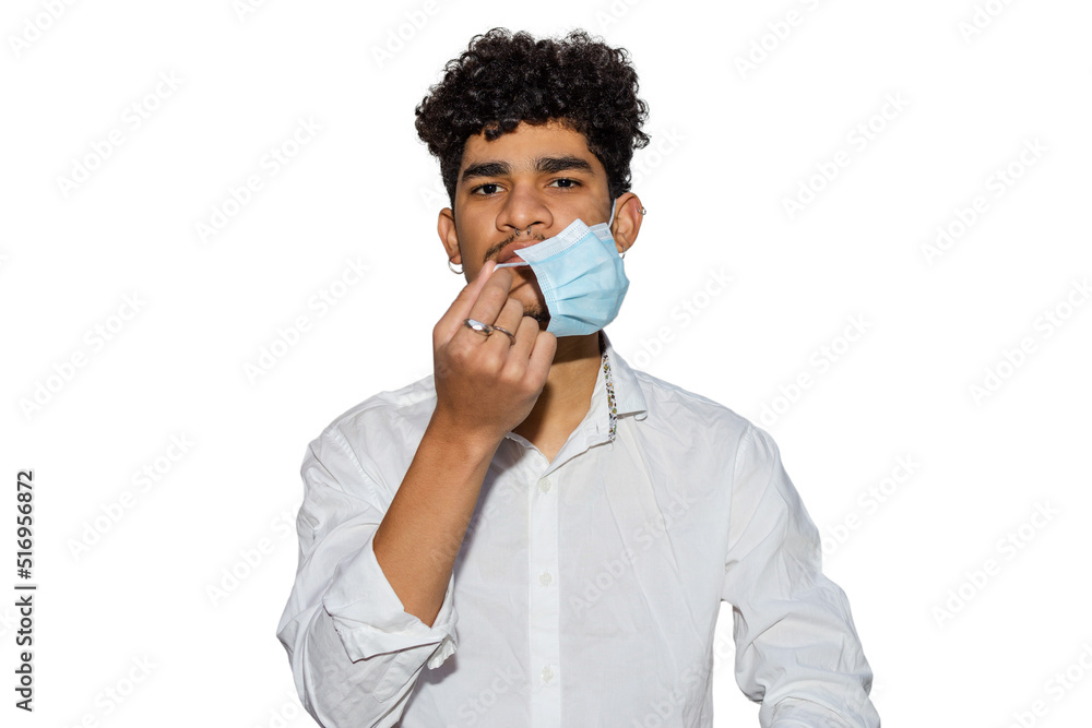Young Hispanic man with curly hair putting on a face mask to protect himself from the pandemic or respiratory diseases isolated on white background Young Hispanic man with curly hair putting on a face mask to protect himself from the pandemic or respiratory diseases isolated on white background