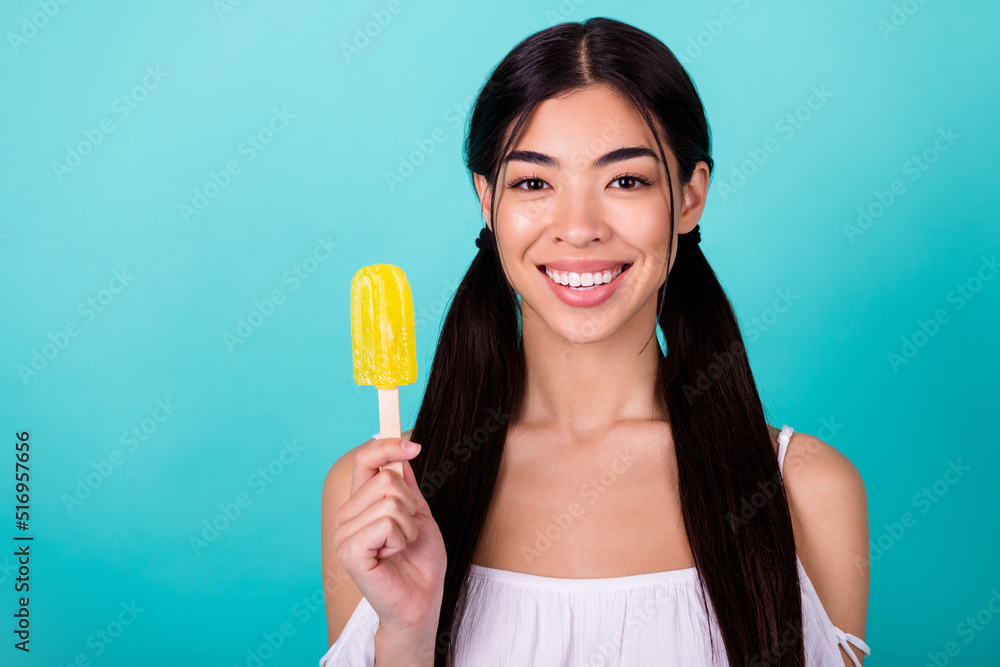 Photo of funny shiny lady wear white top holding frozen fruit ice empty space isolated turquoise color background Photo of funny shiny lady wear white top holding frozen fruit ice empty space isolated turquoise color background