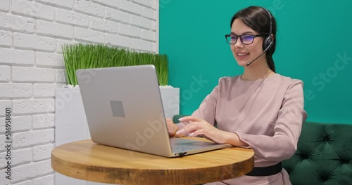 Confident female office worker wears headset conference video calling 