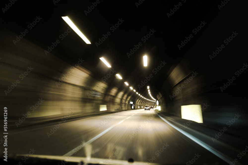 driving through an illuminated tunnel, point of view, motion blur driving through an illuminated tunnel, point of view, motion blur