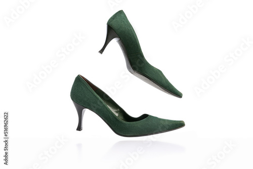 Woman's vintage style footwear. Green kitten-heel shoes isolated on white background. Concept of art, ad , 60s, 70s retro style fashion. Timeless classic