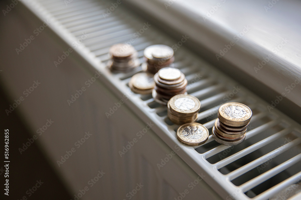 Cost of living crisis. Money on a home radiator heater. Rising cost of energy and bills Cost of living crisis. Money on a home radiator heater. Rising cost of energy and bills