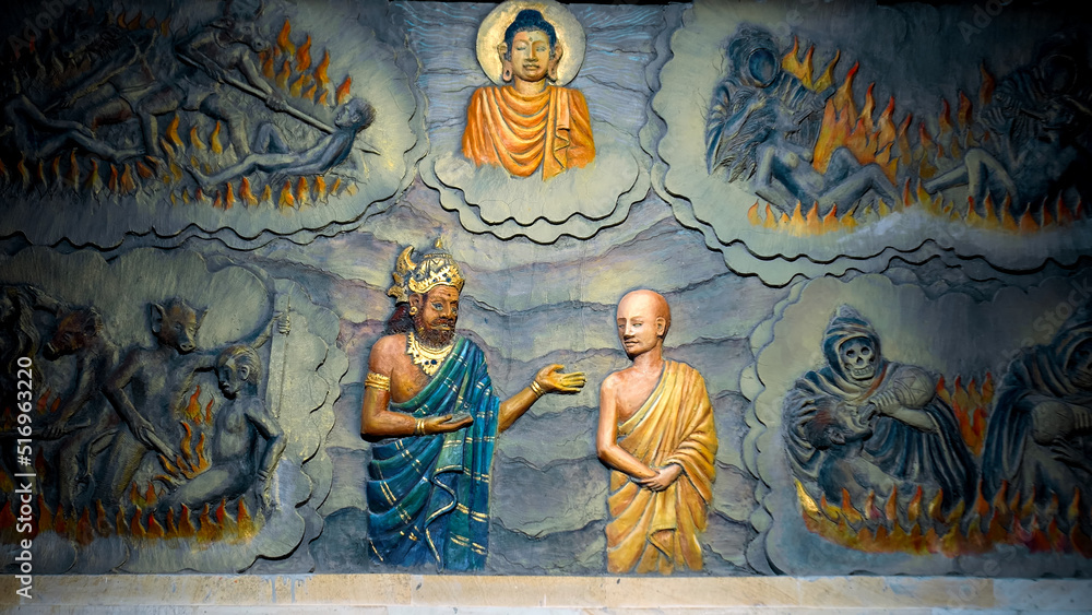 A painting on a wall in a Buddhist temple with a buddha and the history of his arrival and life. A painting on a wall in a Buddhist temple depicting hell. Torment of sinners. 