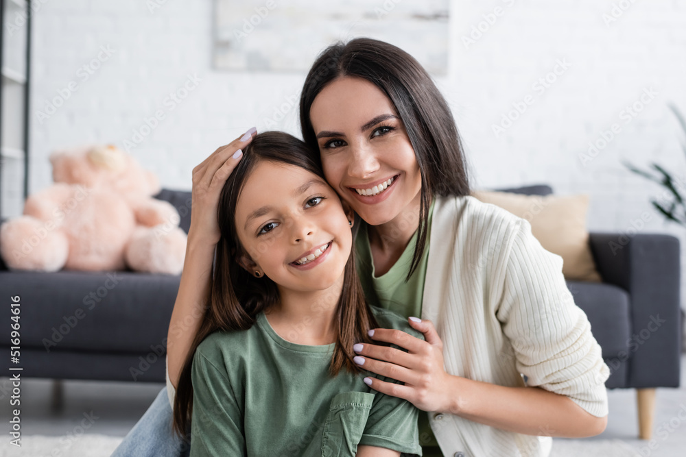 portrait of smiling babysitter and happy girl looking at camera. portrait of smiling babysitter and happy girl looking at camera.