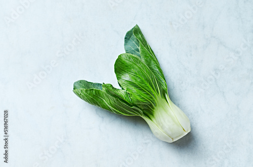 Bok choy on white marble background. Copy space
