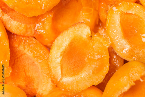 Sweet juicy pitted apricots, apricot slices, top view close-up.