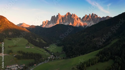 Val Di Funes, Dolomites, Italy - 4K Flying towards and descending at St. Johann Church (Chiesetta di San Giovanni in Ranui) in South Tyrol with the Italian Dolomites at background 
