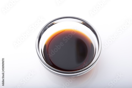 Soy sauce in a bowl shot on a white background