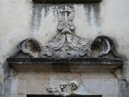 Rivisondoli - Abruzzo - The typical decorations with (skull and bones) that dominate the portal of the deconsecrated church of Santa Maria della Concezione or Suffragio dei Morti photo