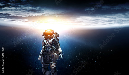 Fototapeta Naklejka Na Ścianę i Meble -  Astronaut walking on an unexplored planet