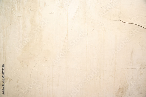 Textured  abstract pastel beige background with stains and  cracks. © greola84