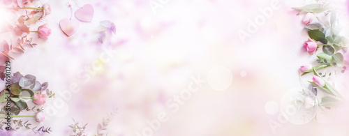 Wedding background. Floral dekoration on tender pink bokeh background. Horizontal top view for wedding cards and banner.