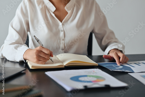 Close up with Asian businesswoman working with papers document, Business and Financial concept. © saltdium