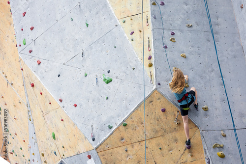 teen girl climbing up the wall