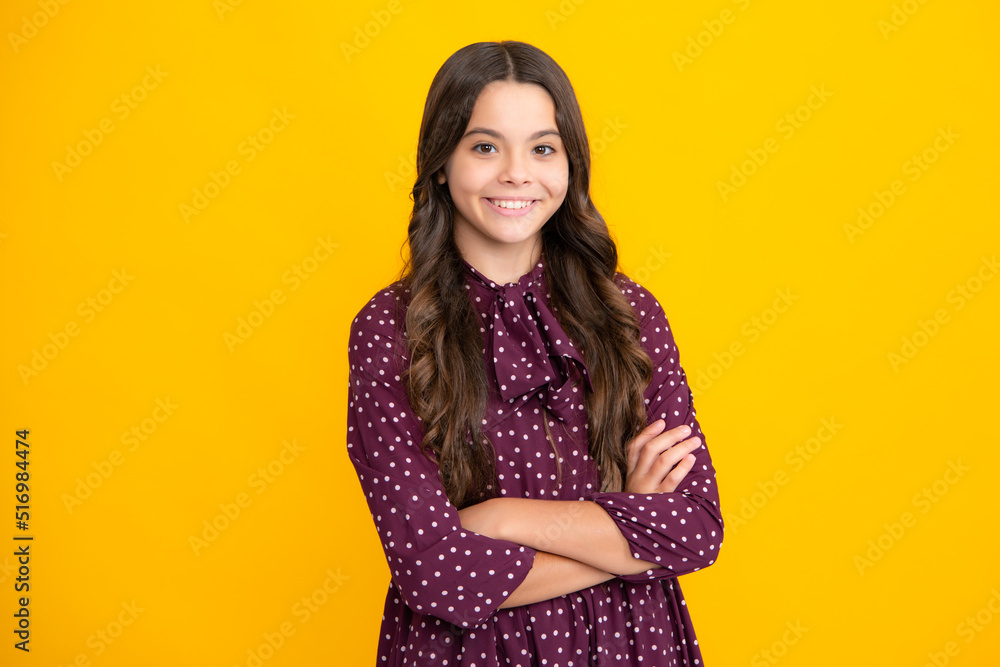 Cute little teenager girl crossing arms over yellow background. Cute little teenager girl crossing arms over yellow background.