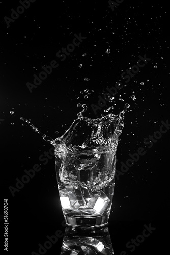 Water splashed into a glass of ice.