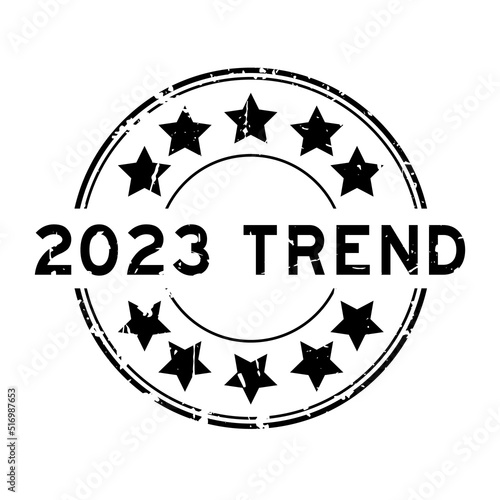 Grunge black 2023 trend word with star icon round rubber seal stamp on white background