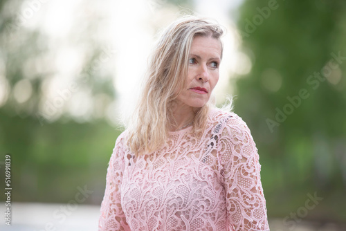 Beautiful elderly blonde woman on a natural background.