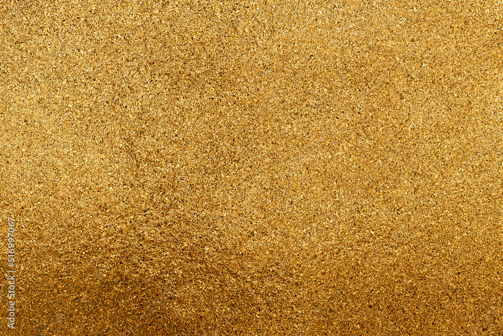 The texture of small gold chips or glitter. The texture of small gold chips or glitter.