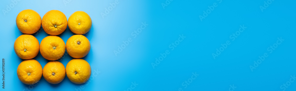 Flat lay with oranges in square shape on blue background, banner. Flat lay with oranges in square shape on blue background, banner.