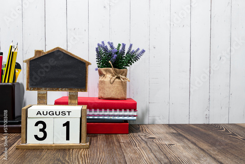 August 31 calendar date text on white wooden block a table. photo