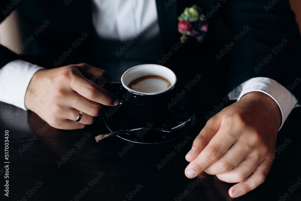 businessman holding cup