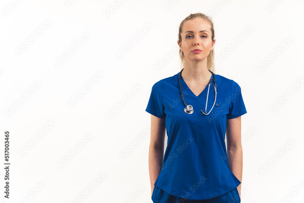 Strong, independent, powerful and professional caucasian woman as a healthcare worker - nurse, doctor, specialist, standing in a dark blue uniform and looking at camera with confidence. White Strong, independent, powerful and professional caucasian woman as a healthcare worker - nurse, doctor, specialist, standing in a dark blue uniform and looking at camera with confidence. White
