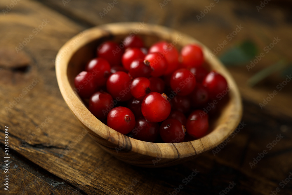 Fresh ripe cranberry in a wooden bowl Fresh ripe cranberry in a wooden bowl