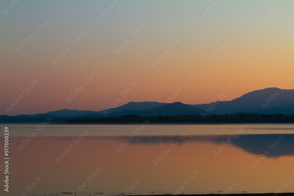 Lake at sunset blue hour. Wetland and Mountain landscape. Lake at sunset blue hour. Wetland and Mountain landscape.