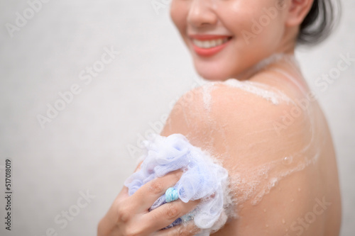 Happy beautiful woman is taking a shower