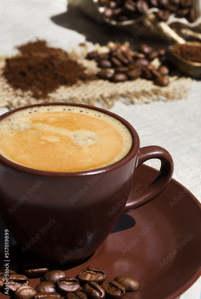 Coffee cup on the background of coffee beans on the table. Coffee cup on the background of coffee beans on the table.