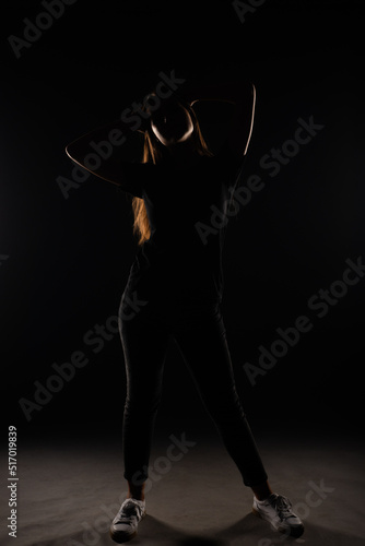 Silhouette of a girl posing with her hands