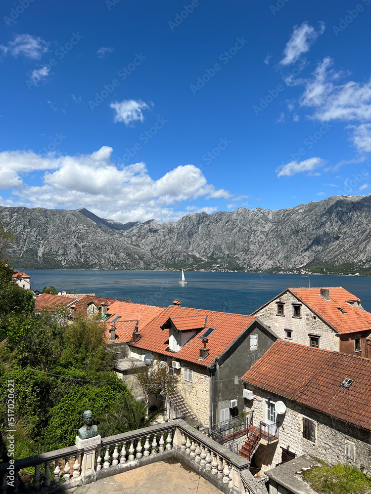 View through the roofs of houses on a sailboat in the Kotor Bay. Montenegro